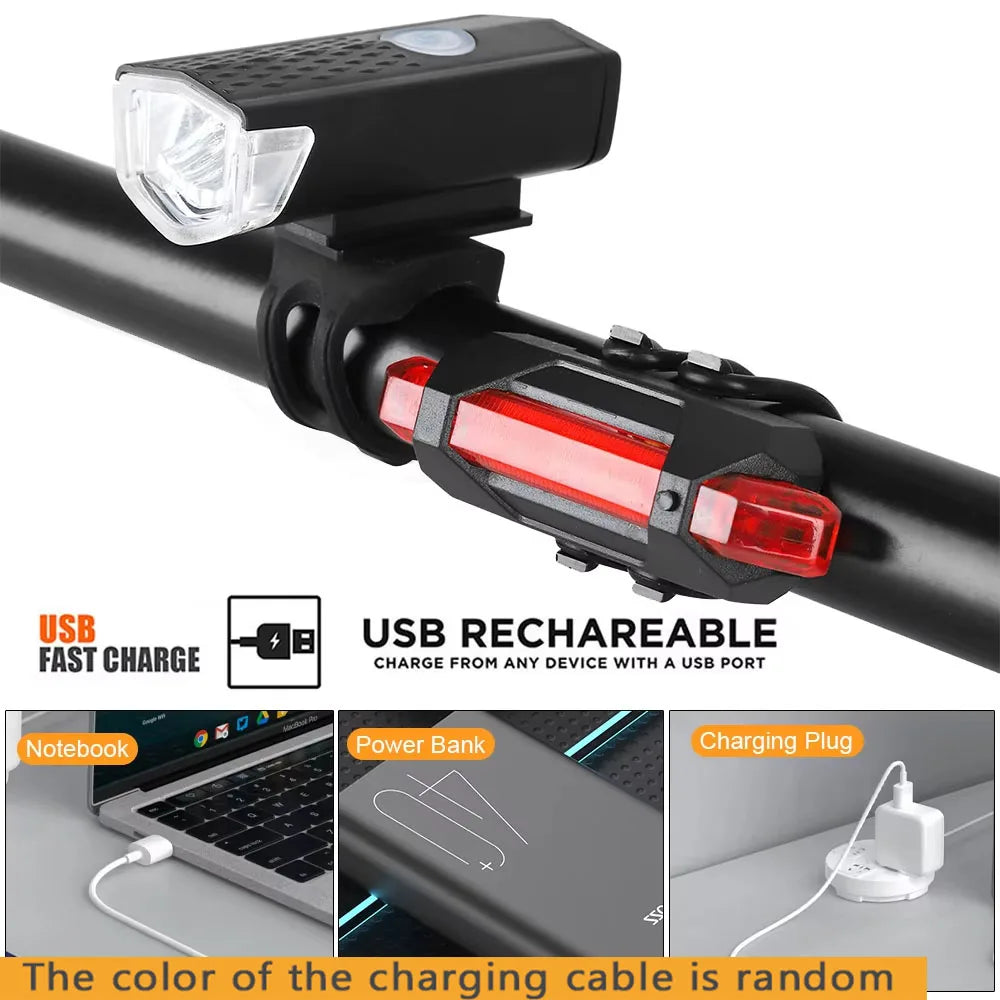 USB rechargeable bike light close-up: clear front headlight and red rear taillight on bracket