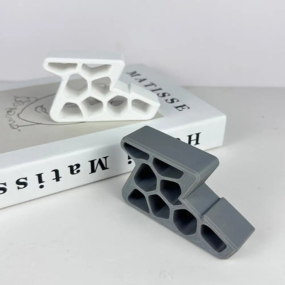 Gray and white door stopper wedges next to a product box
