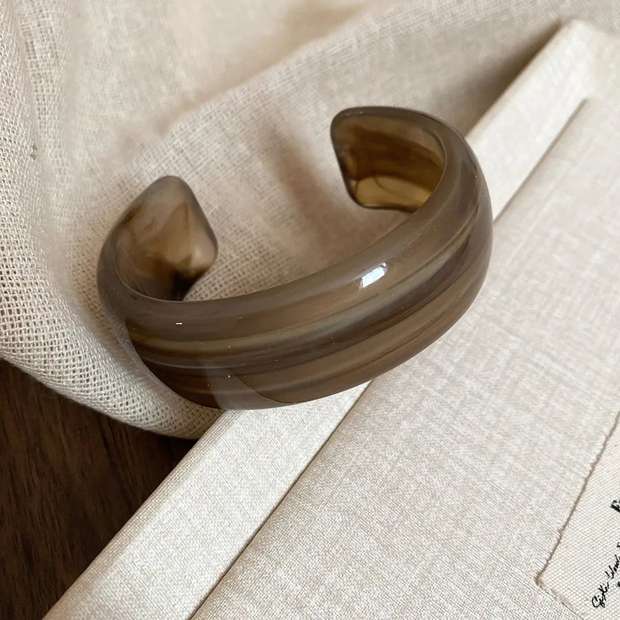 Shiny acrylic open bangle in smoky brown, wide curved statement bracelet