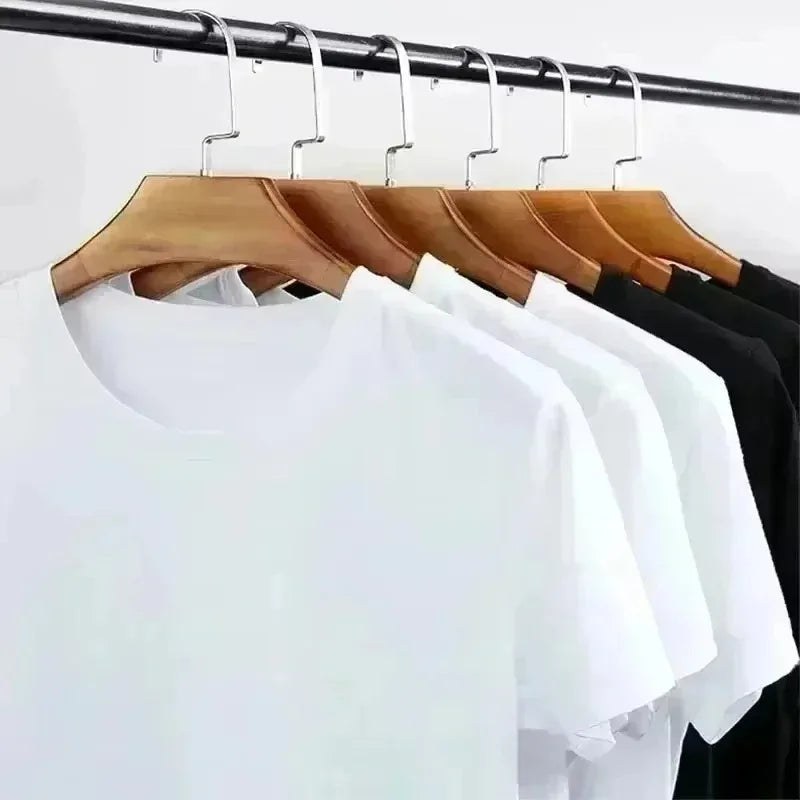 Hanging short-sleeve T-shirts in white and black on wooden hangers