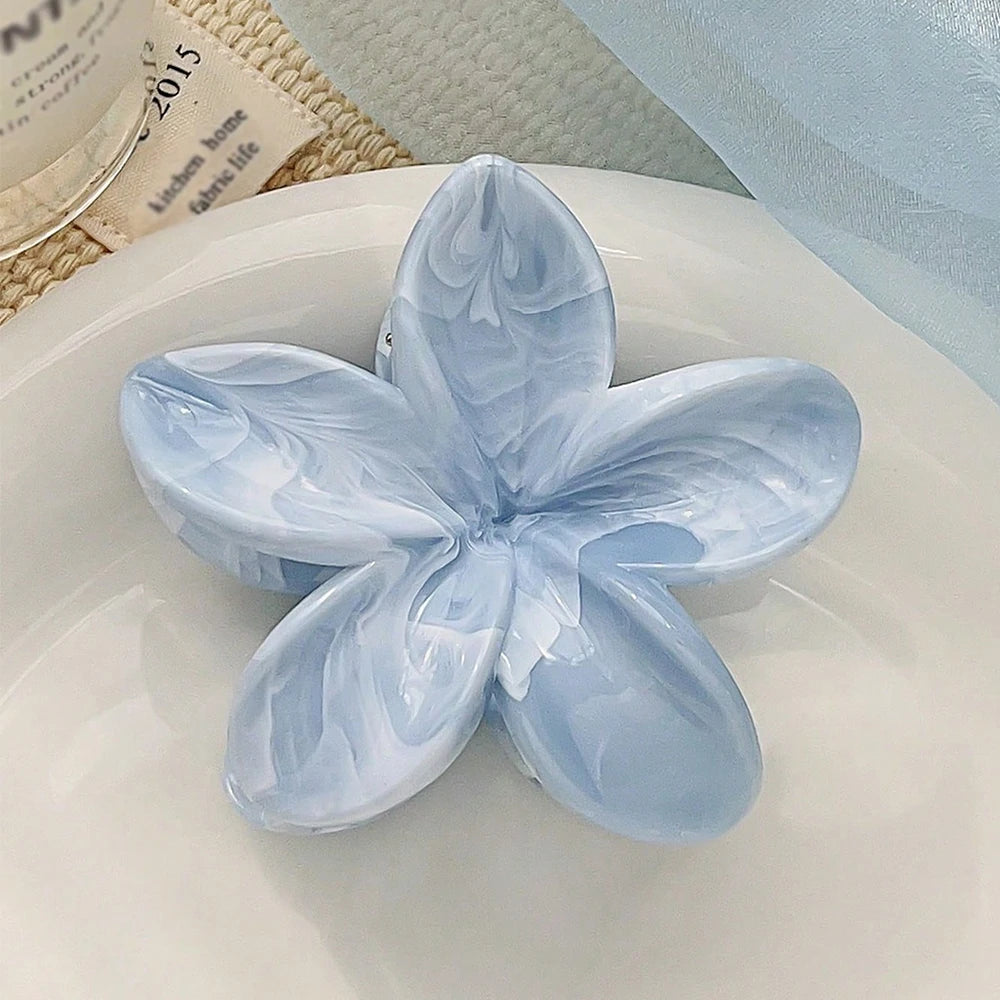 Light blue daisy flower hair claw clip with layered petal texture