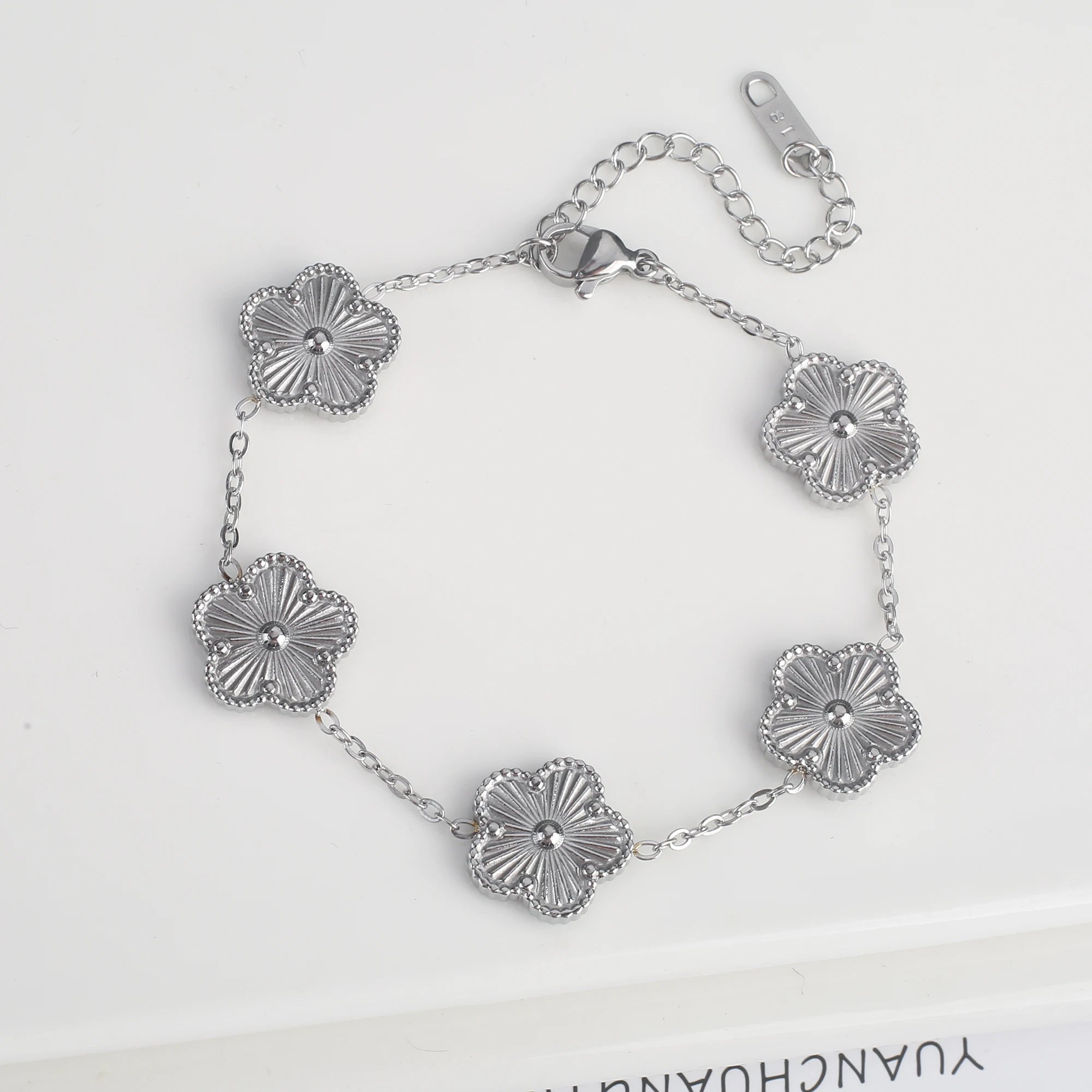 Adjustable silver bracelet with five scalloped flower medallion charms and chain