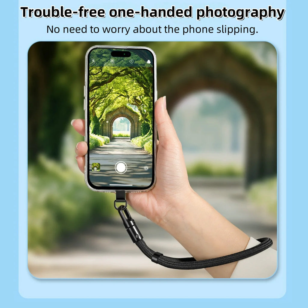 Black adjustable mobile phone lanyard strap with self-locking clip on a held phone.