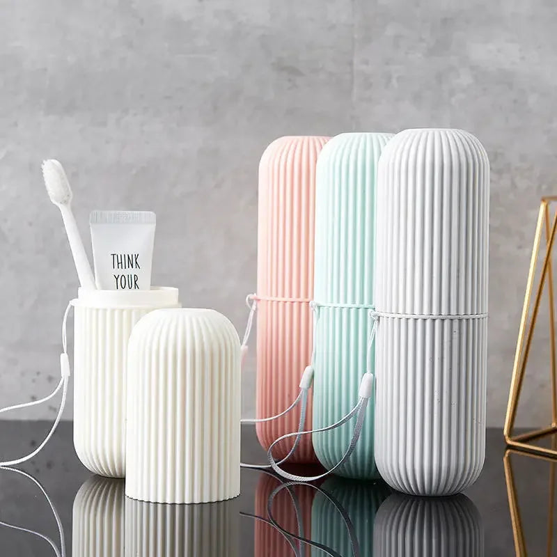 Set of ribbed travel toothbrush holder cups in white, mint, pink, and gray