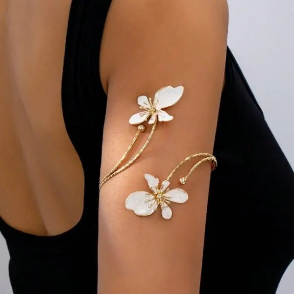 Floral open cuff armlet with white flower charms and gold-tone adjustable chain bracelet