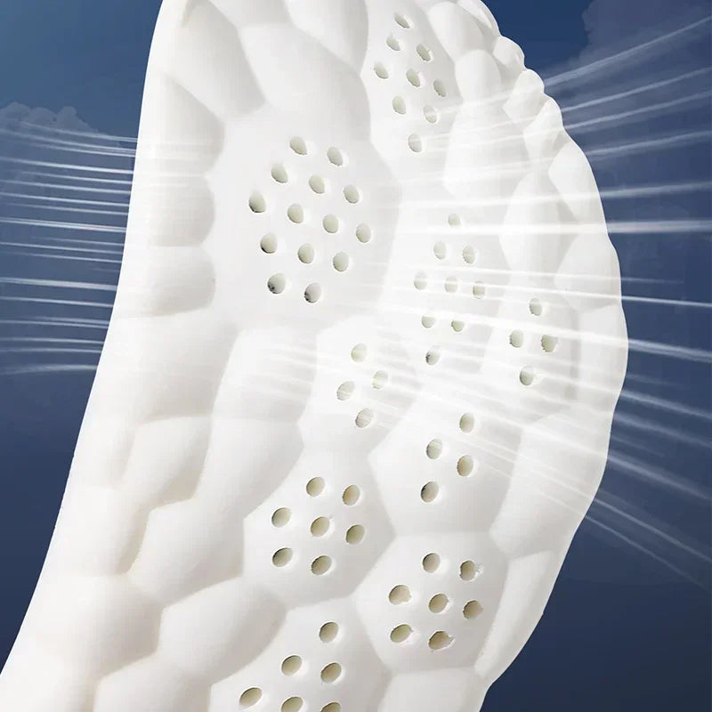 Close-up of white running insole top with dotted ventilation holes and foam pattern