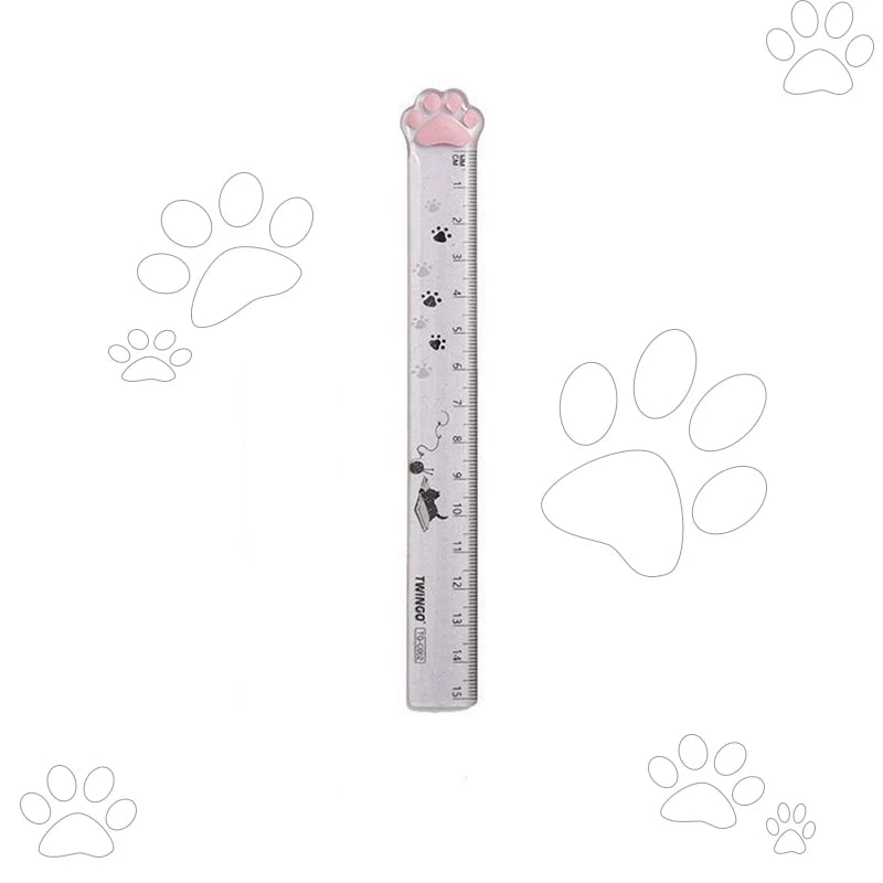 Grey plastic straight ruler with cat paw-shaped top and paw-print scale
