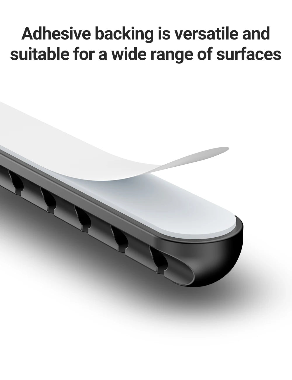 Black adhesive cable holder clip with multiple cord slots attached beneath desktop