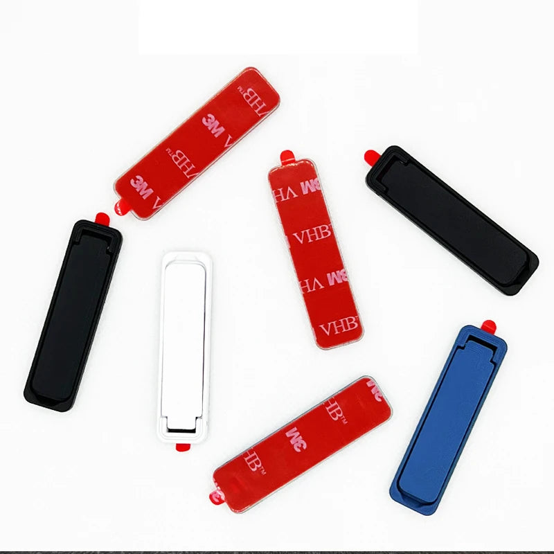 Assorted foldable phone back sticker stands in red, white, black, and blue