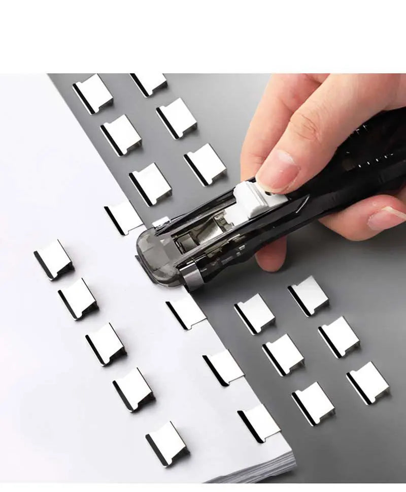 Hand loading and pressing mini push stapler clip onto paper stack