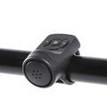 Black electric bicycle horn on handlebar with circular perforated speaker face