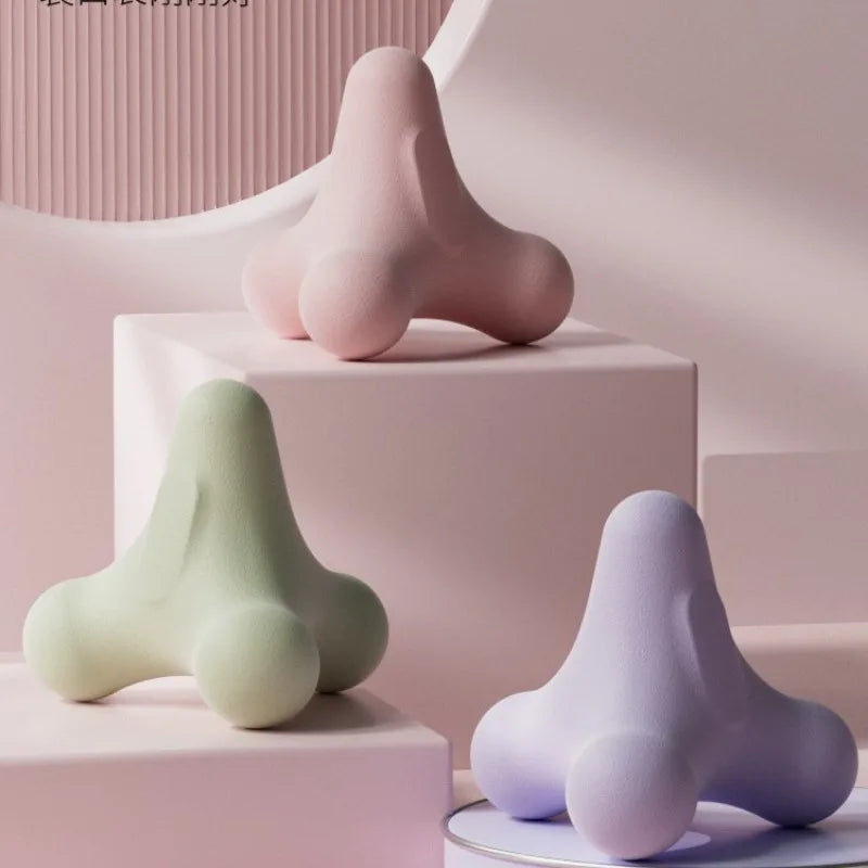 Set of massage fascia balls in green and purple tones on a pedestal for targeting points