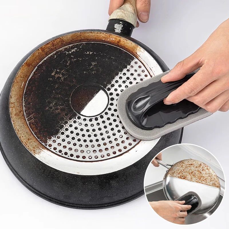 Kitchen emery sponge brush cleaner with black handle scrubbing a pan surface