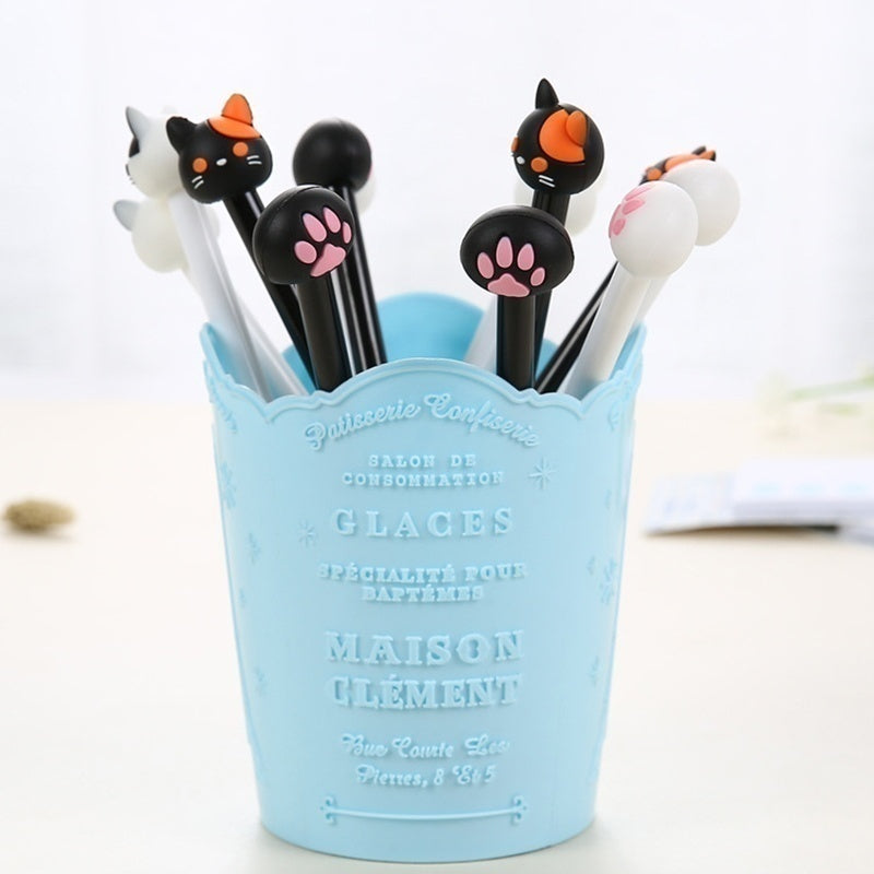 Kawaii cat gel pen set (10-pack) in a light blue cup with black pens and paw caps