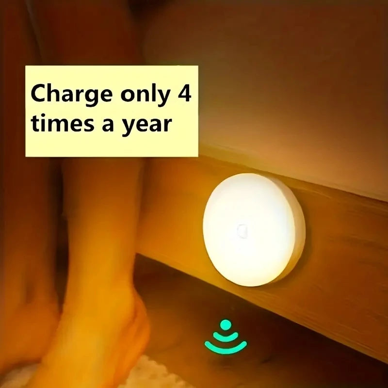 Round motion sensor LED night light with warm glow, white housing