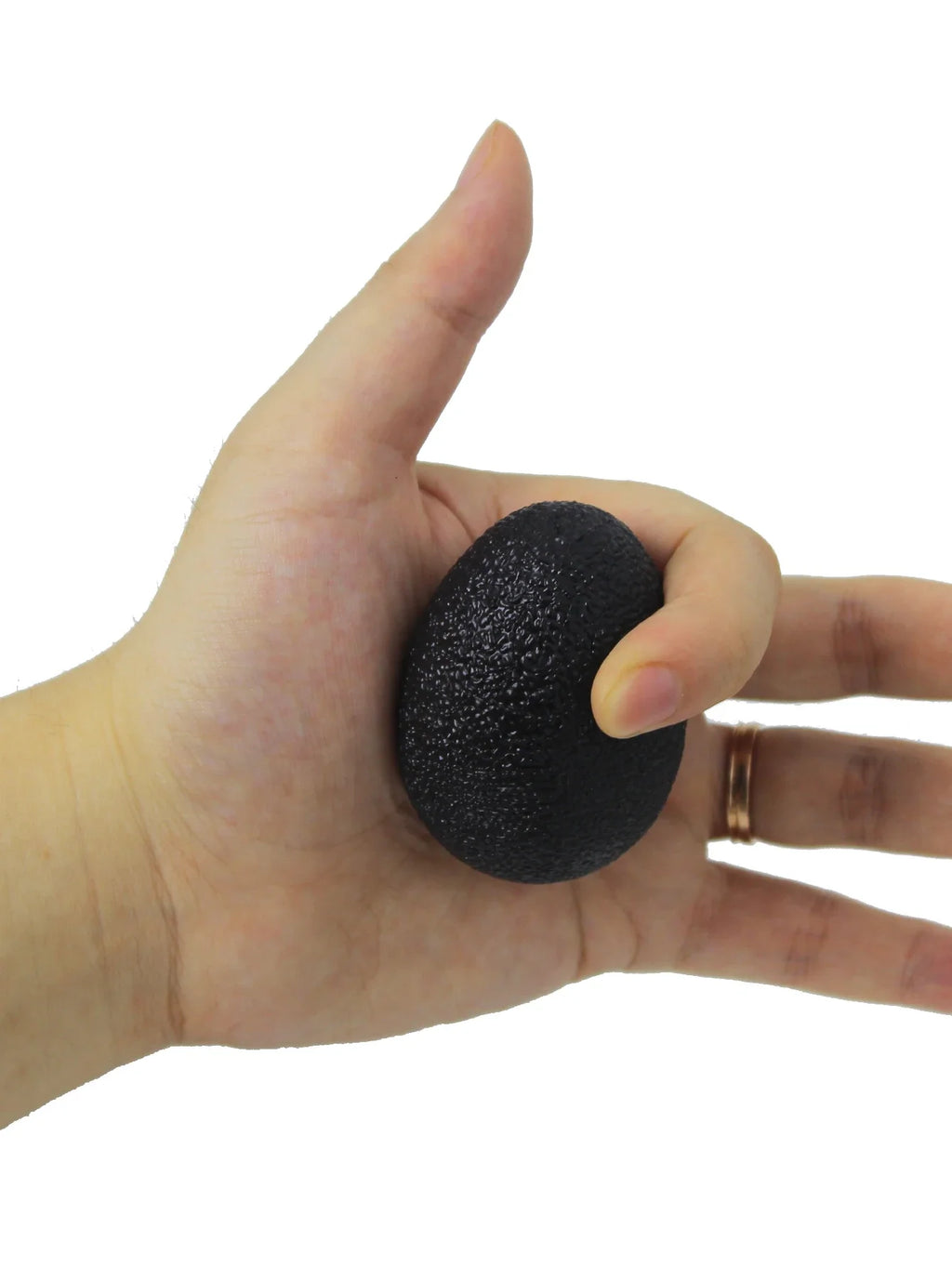 Black egg-shaped grip strength ball held with thumb and fingers for rehab exercise