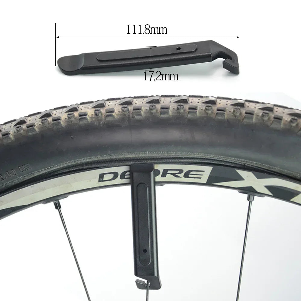 Bicycle tire tool lever beside a bicycle tire for quick roadside tire repair