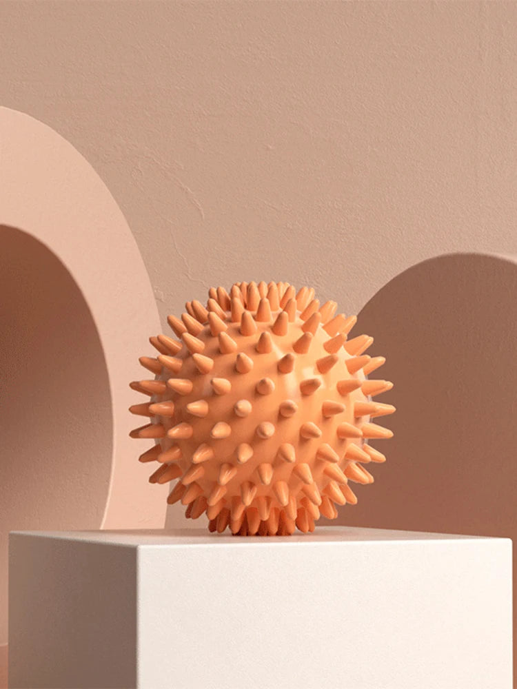 Orange spiky fascia massage ball with pin-like bumps
