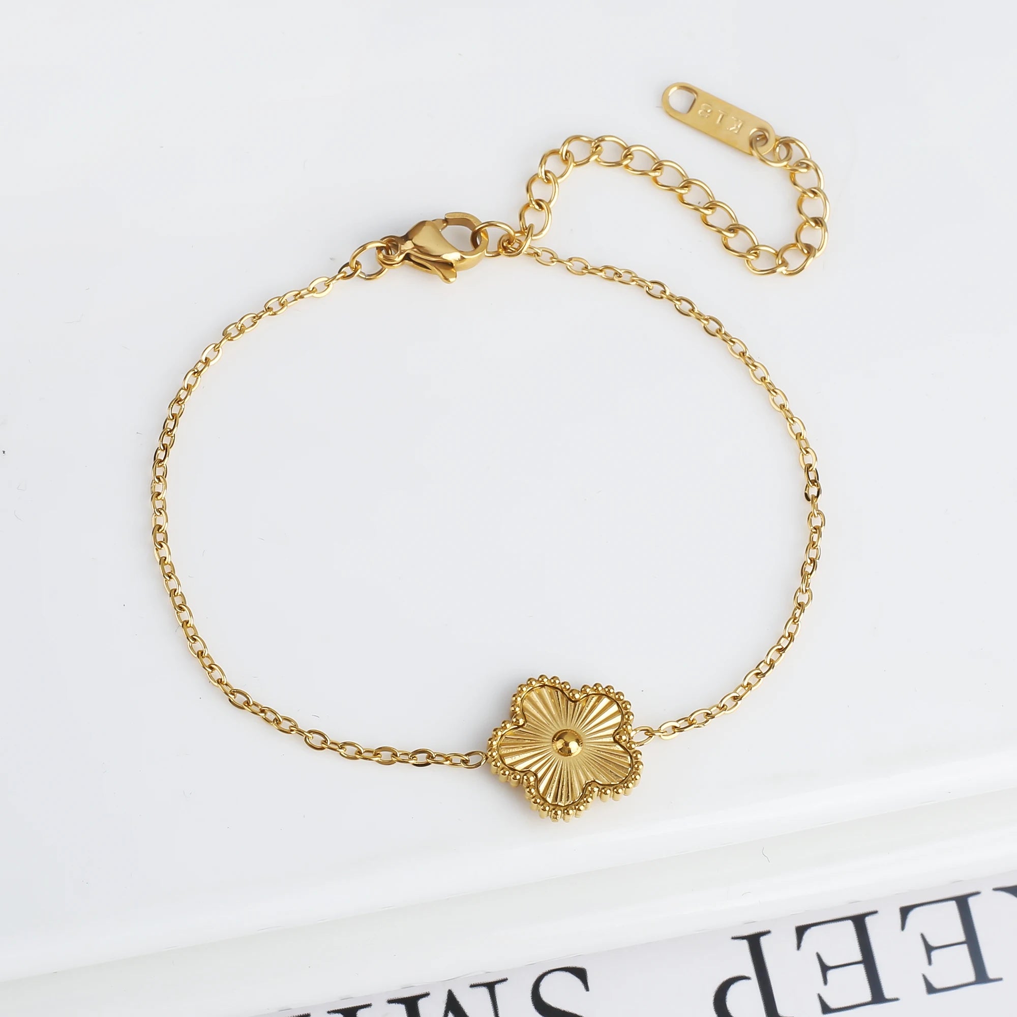 Adjustable gold bracelet with five scalloped flower medallion charms and chain