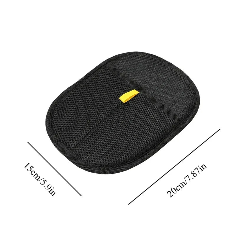 Black pet grooming mitt with mesh texture and yellow tab, rounded oval shape