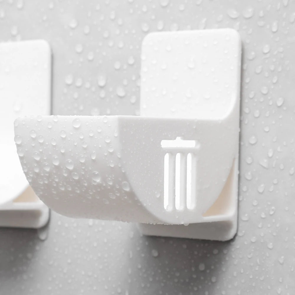 White wall-mounted trash bag dispenser holder with slotted grip, water droplets
