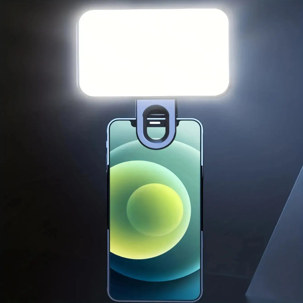 Black clip-on fill light with glowing rectangular LED panel, clips to smartphone