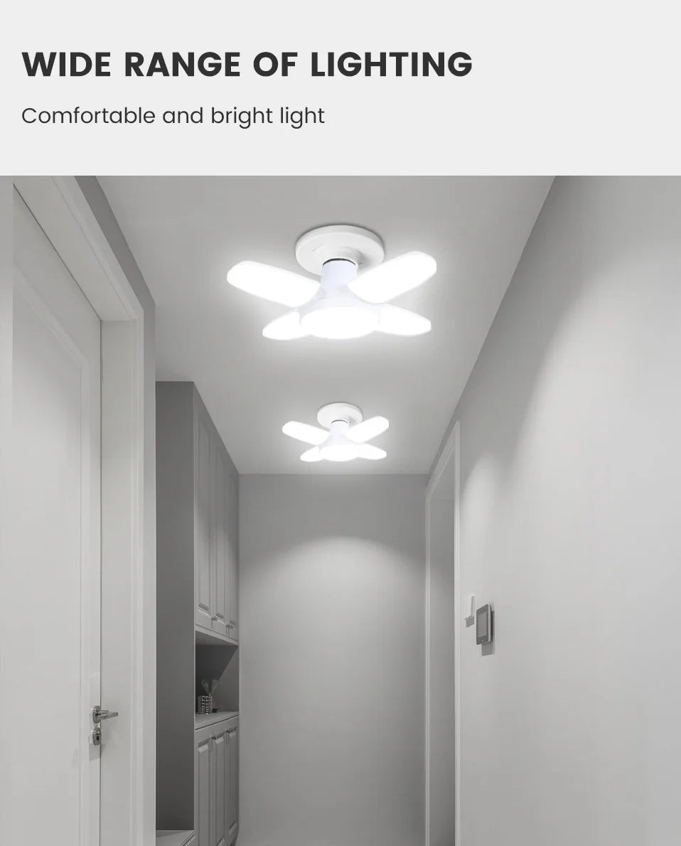 Folding LED ceiling light with four fan blades, emitting bright white light in a hallway