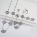 Three-piece clover jewelry set with five-leaf flower charms, silver tone necklaces and dangling earrings