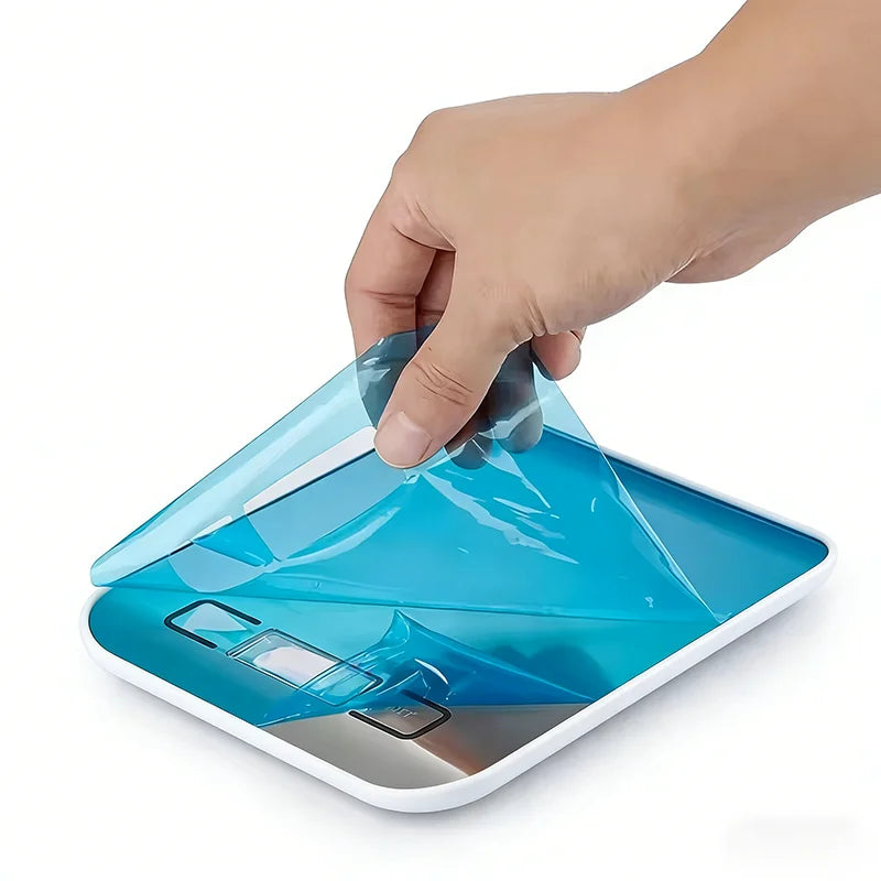 Digital kitchen scale with protective cover removed, viewed from top angle