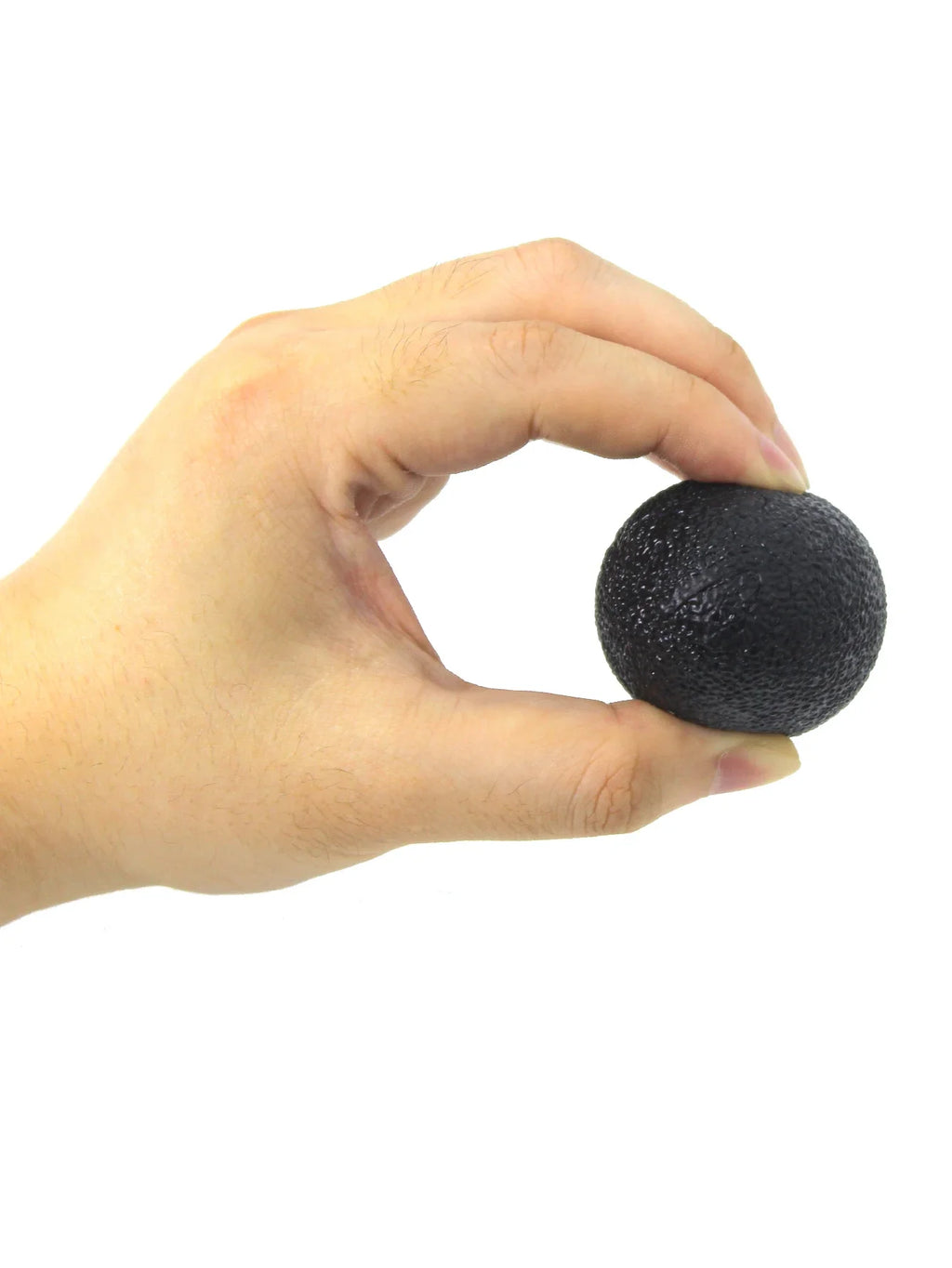 Black egg-shaped grip strength ball gripped between fingers for hand strengthening