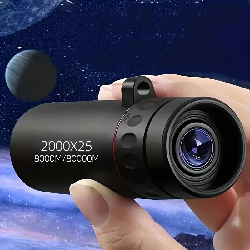 Black compact monocular telescope with large objective lens and red ring, held in hand