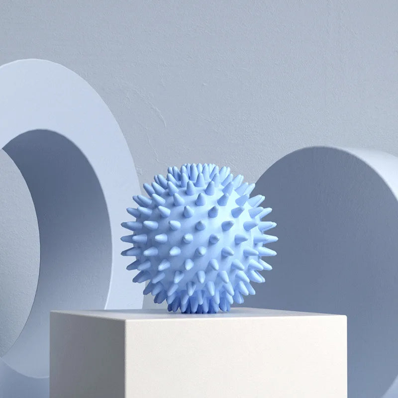 Blue spiky massage ball on a pedestal