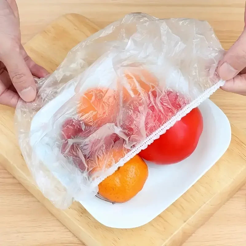 Disposable clear food cover plastic wrap sheet over a plate of fruit