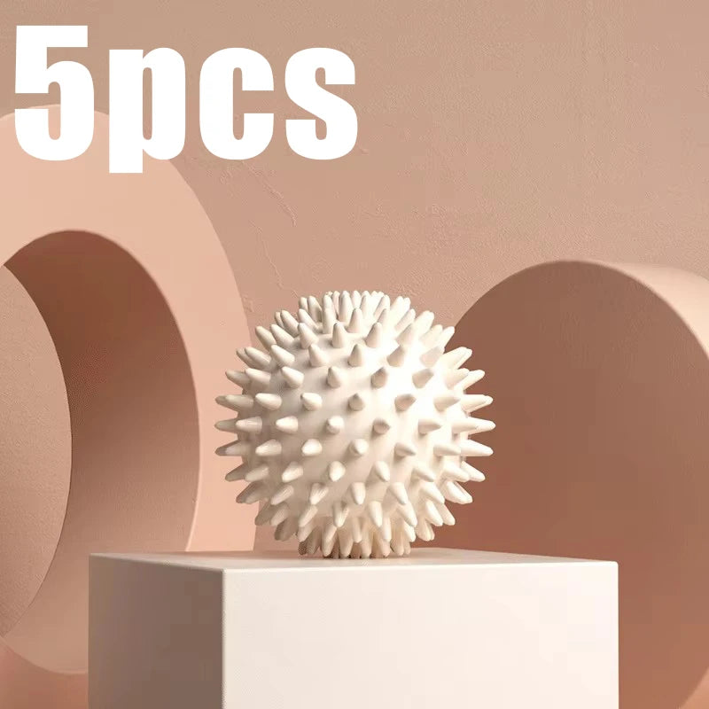 White spiky fascia massage ball for muscle relaxation, shown on a block pedestal