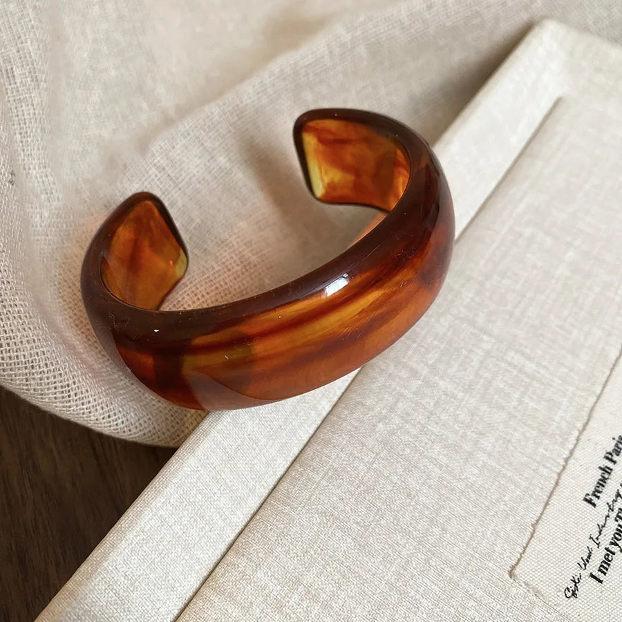 Brown amber glossy open acrylic bangle with smooth curved open cuff design