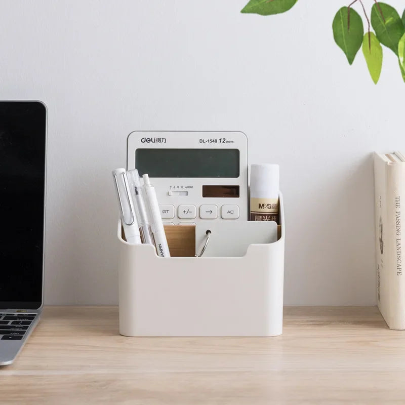White plastic desktop organizer box holding pens and a small calculator device