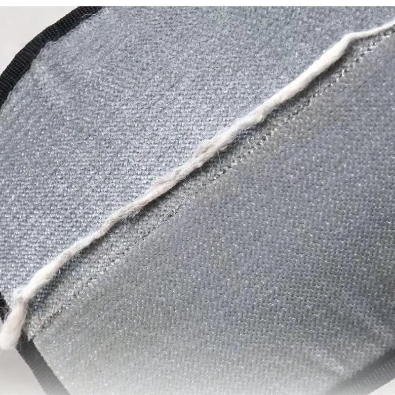 Gray grooming brush fabric on pet mitt with white edge stitching and black border