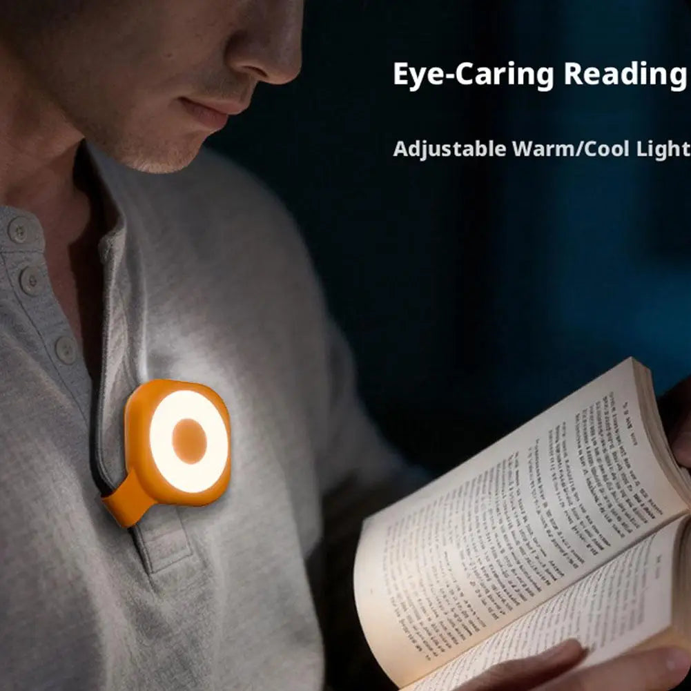 Mini magnetic LED phone light with warm glowing ring clipped to a shirt pocket