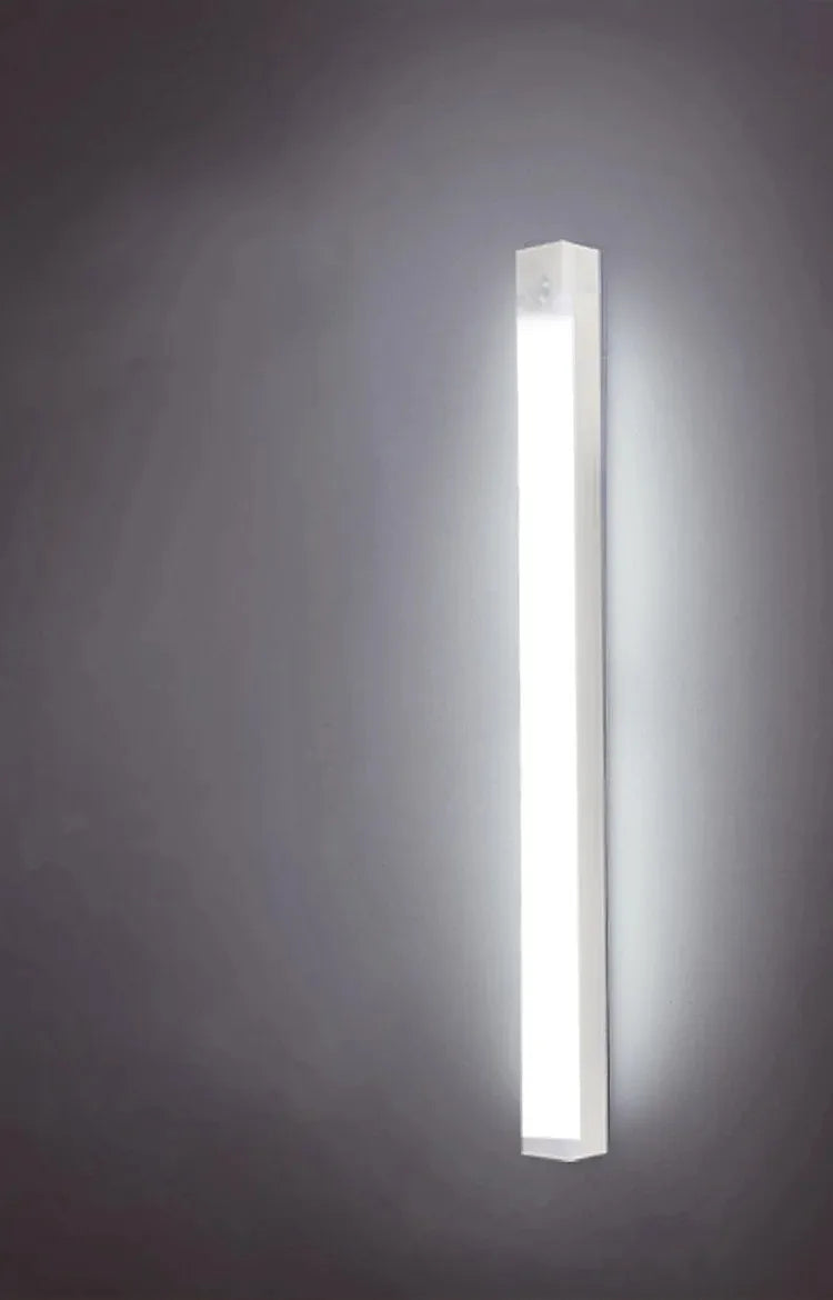 Slim white LED night light bar glowing vertically