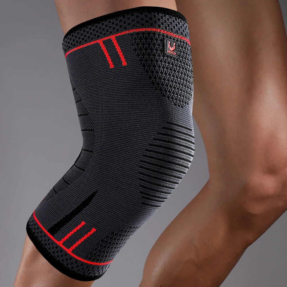 Black knee brace sleeve with red accent stripes and elastic compression fit