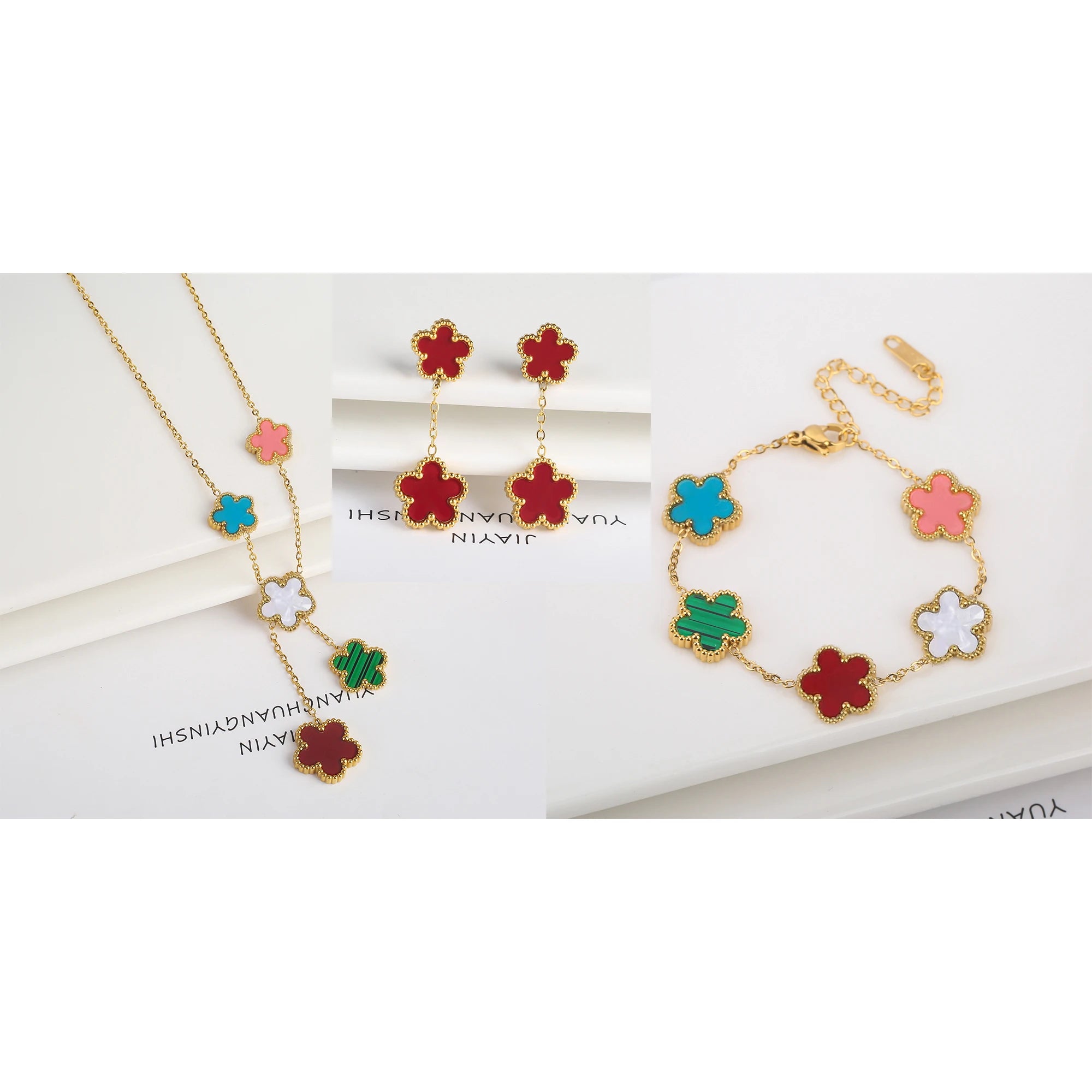 Three-piece clover jewelry set with red, pink, and blue enamel five-leaf charms, gold tone necklace