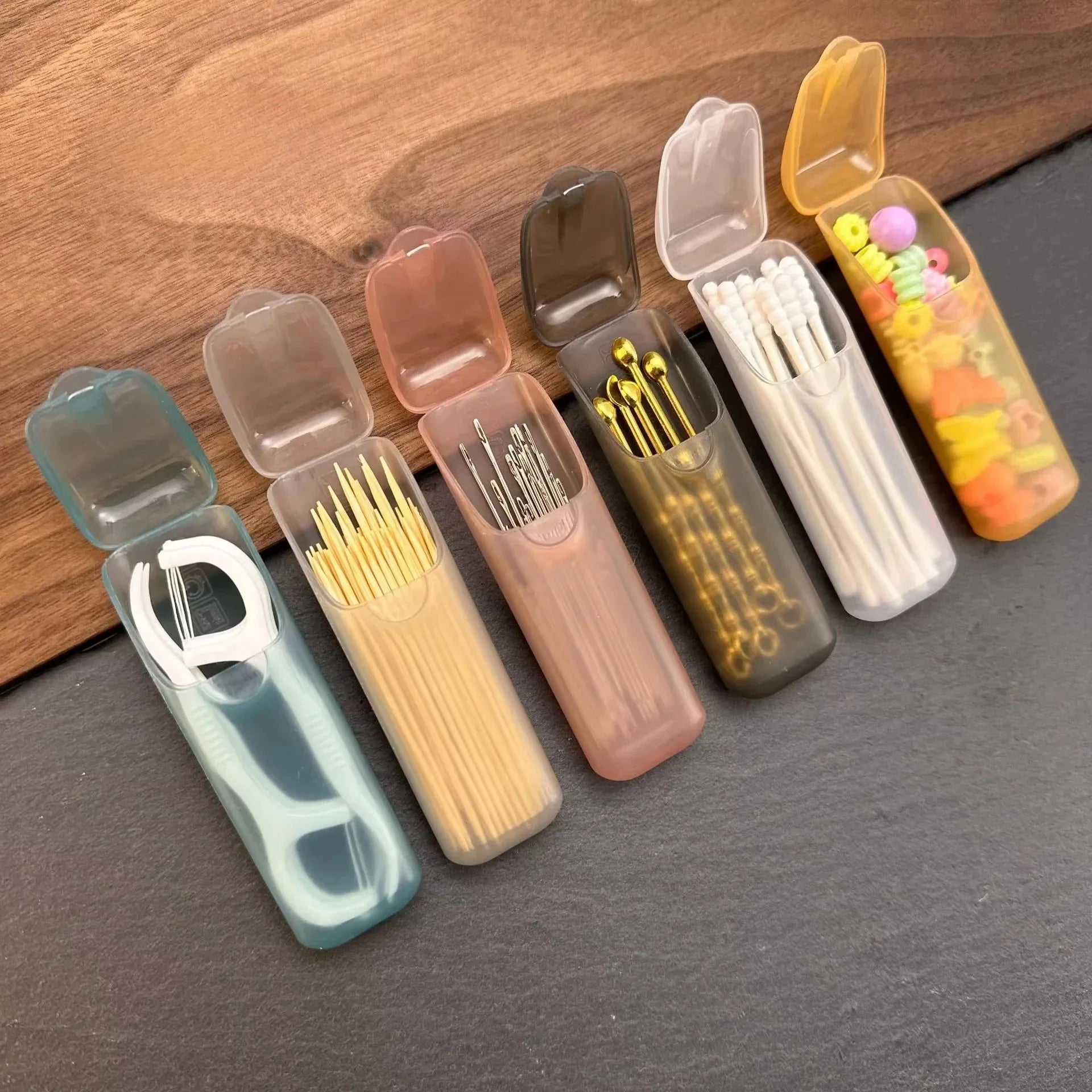 Mini portable storage box set with translucent cases, open tops showing toothpicks and swabs