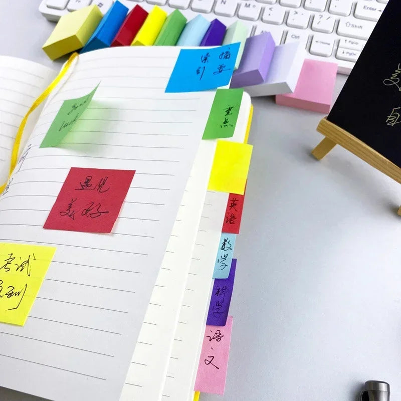 Lined memo sheets with colorful sticky note tabs in green, blue, yellow, purple, and pink