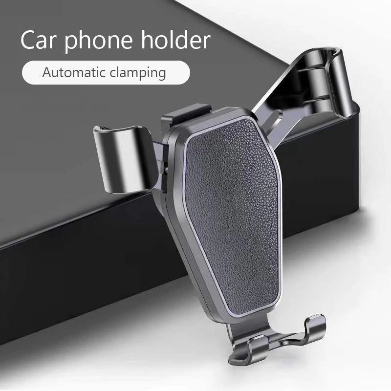 Black gravity car phone holder with textured cradle and twin vent clamps on dashboard