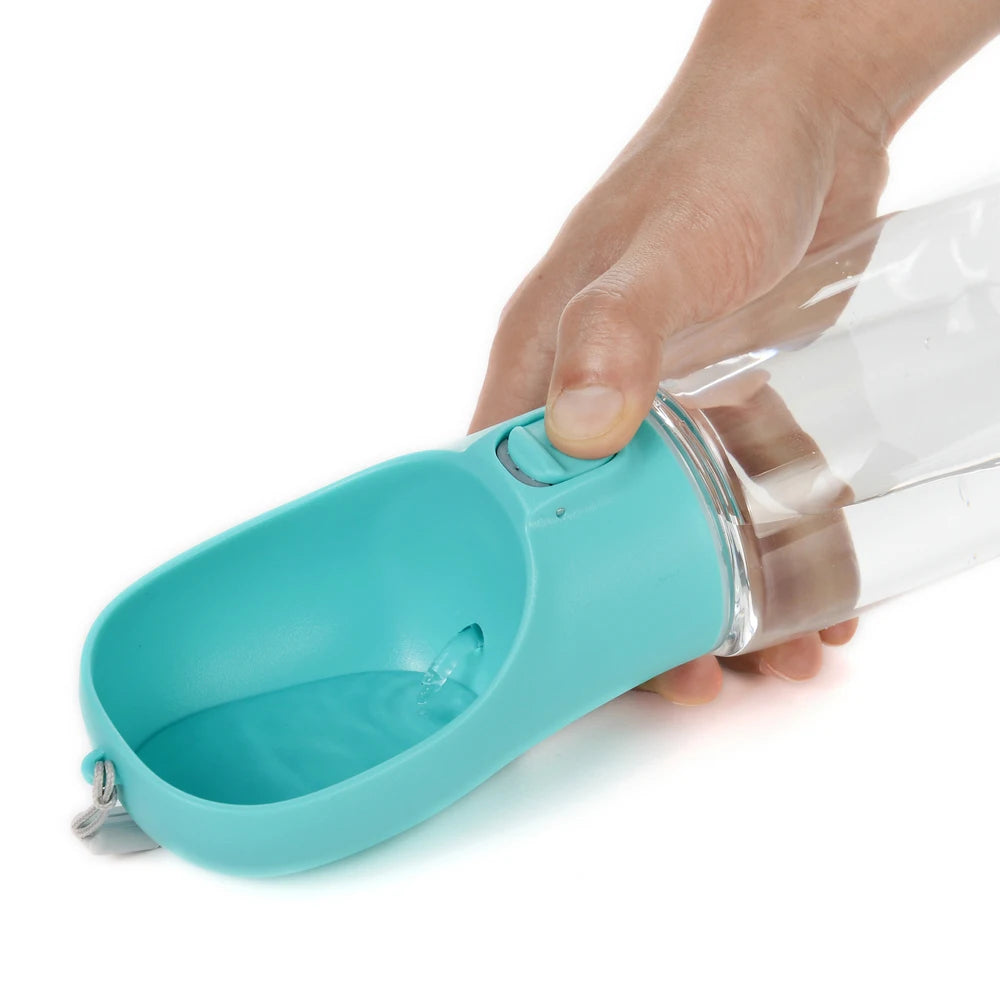 Turquoise portable pet water bottle with flip bowl, held upright