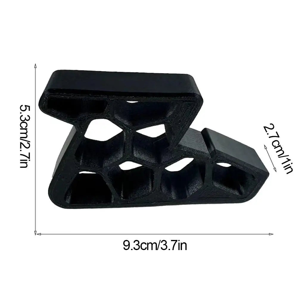 Black door stopper wedge with size labels, showing hex cutout design