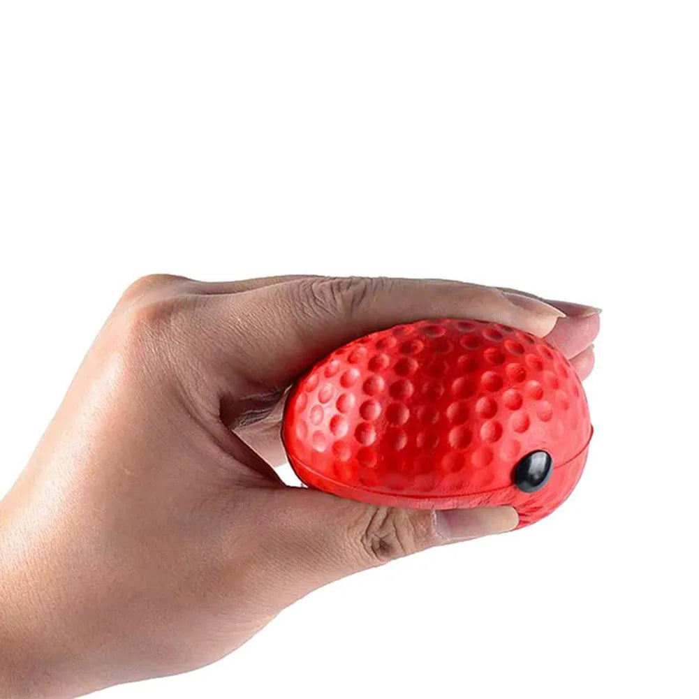 Red textured reflex punch ball held in a hand, with small black attachment