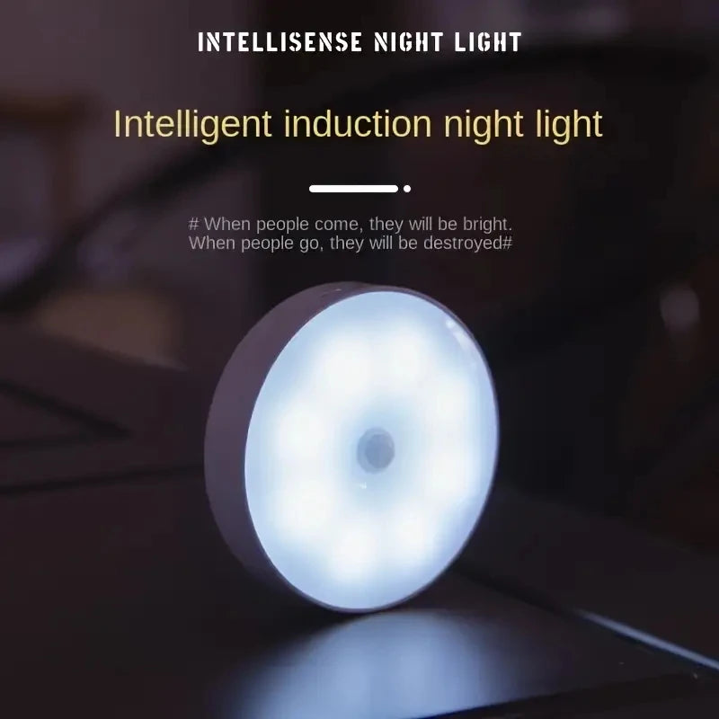 Round motion sensor LED night light glowing blue-white, wall surface mount