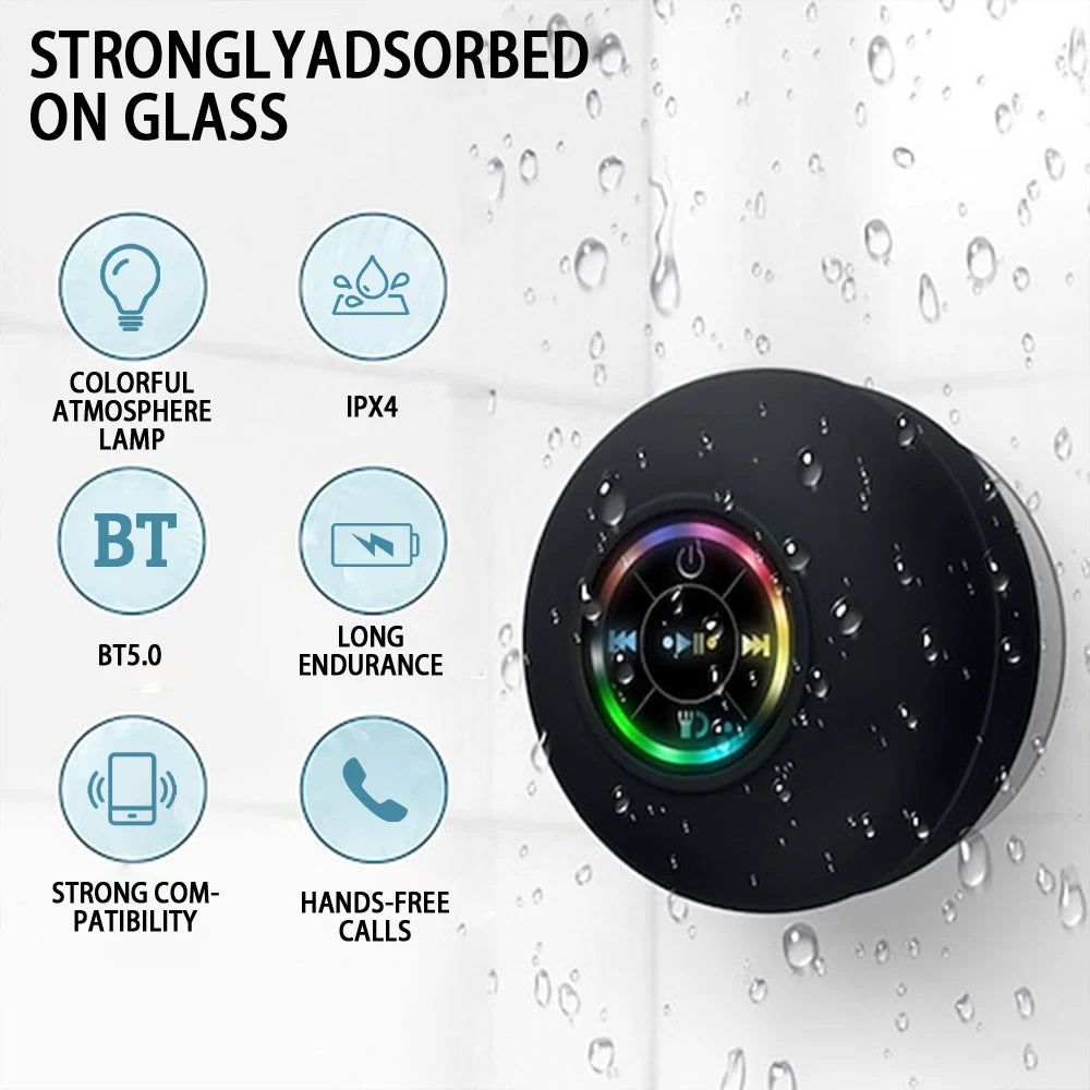 Black Bluetooth speaker with RGB light ring on a rain-dotted surface, suction-mounted design