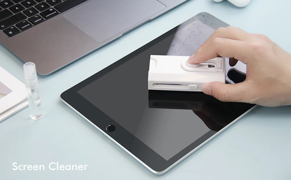 Tablet screen cleaning with a flat brush tool held over the display